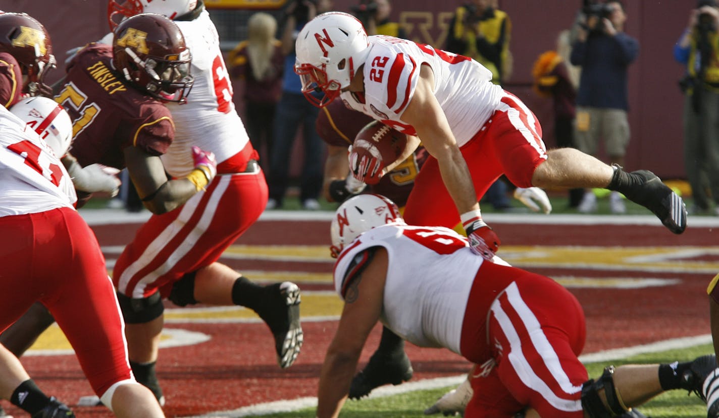 Minnesota Gophers football vs. Nebraska Cornhuskers. Nebraska running back Rex Burkhead (22) jumped over a blocker and stepped into the end zone for a first half touchdown.