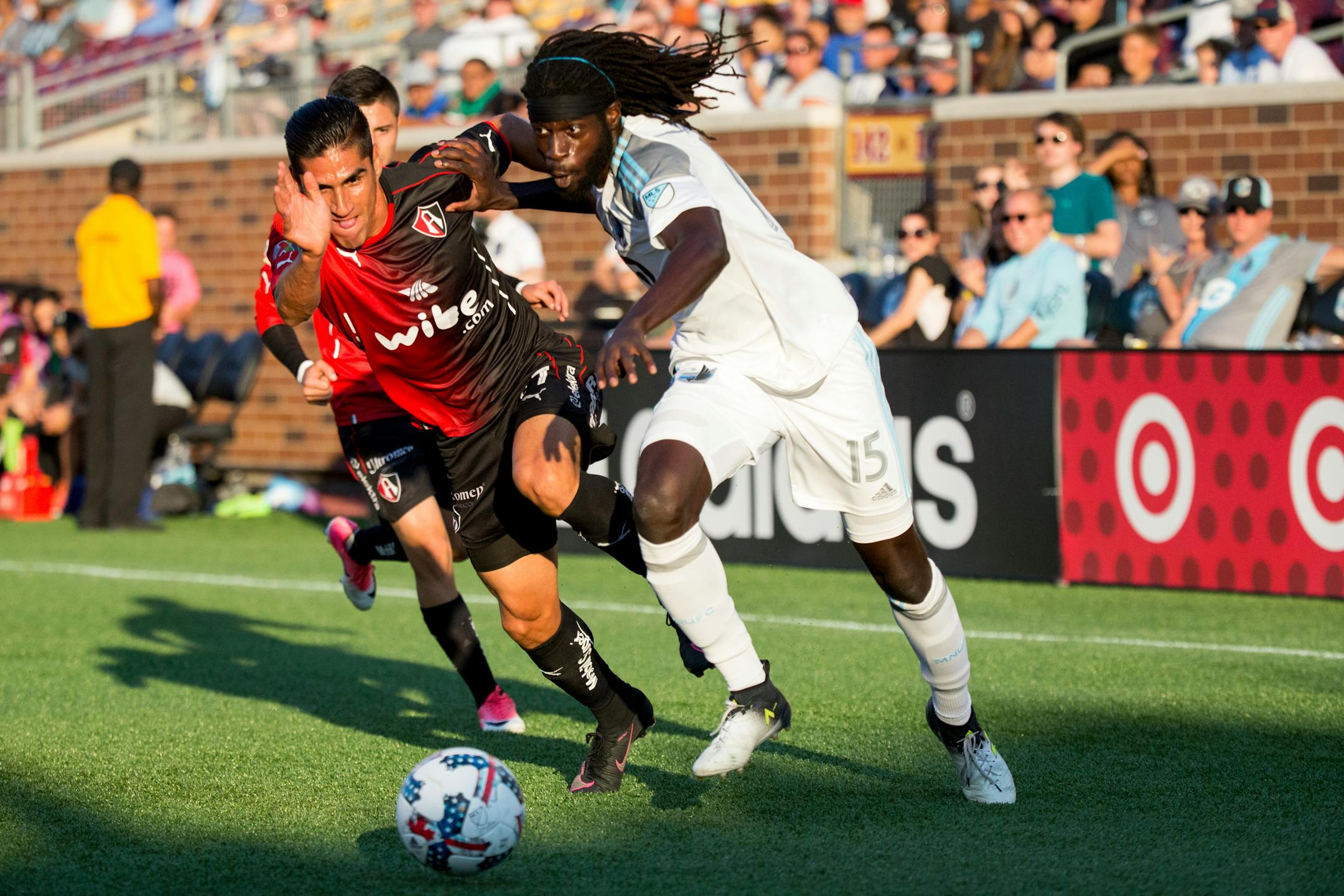 Minnesota United's Ismaila Jome, right, and Atlas' Jose Maduena vie for the ball during the first half ofan international friendly soccer match Saturday, July 15, 2017, in Minneapolis.