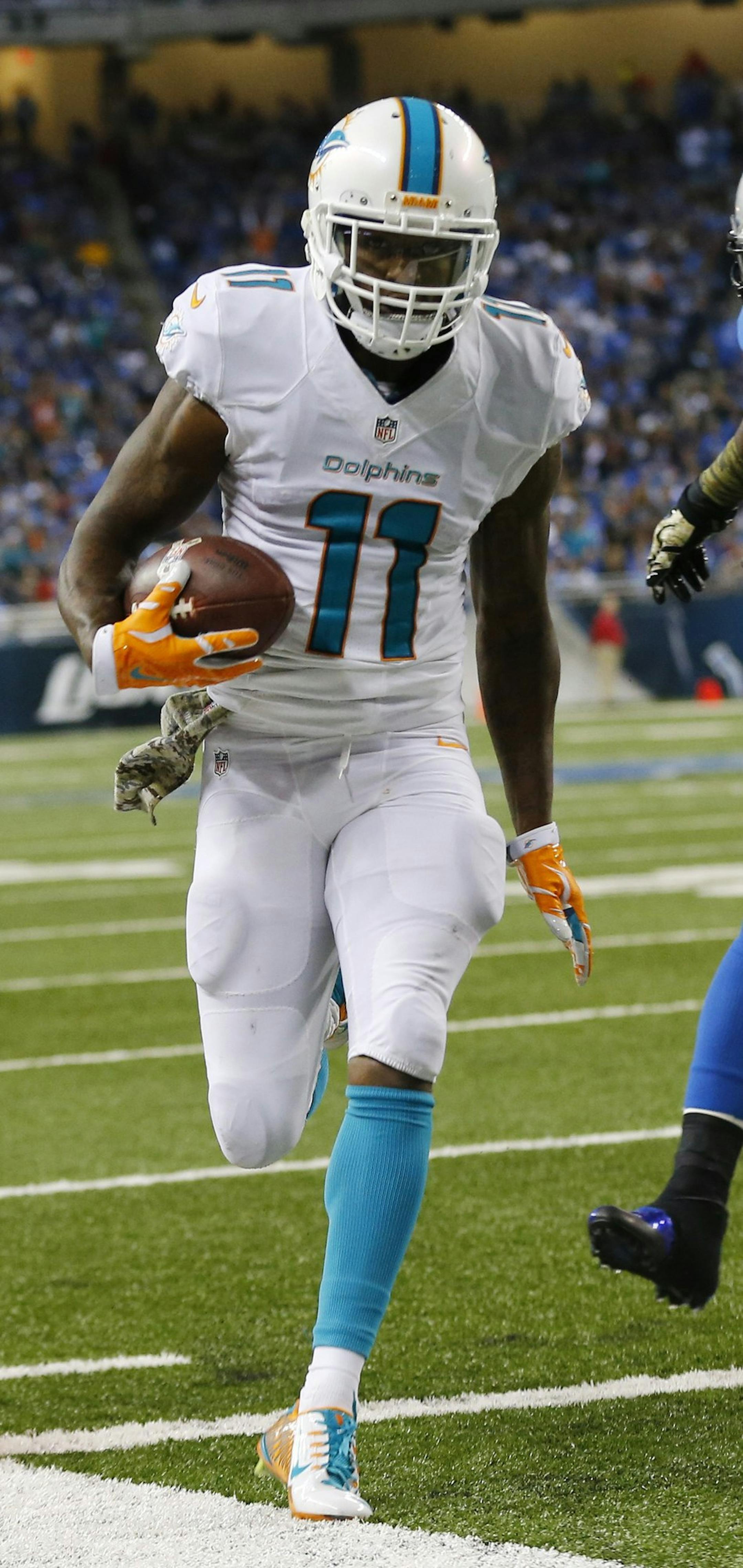 Miami Dolphins wide receiver Mike Wallace (11) outruns Detroit Lions outside linebacker Ashlee Palmer (58) for a three-yard touchdown during the second half of an NFL football game in Detroit, Sunday, Nov. 9, 2014. (AP Photo/Paul Sancya)