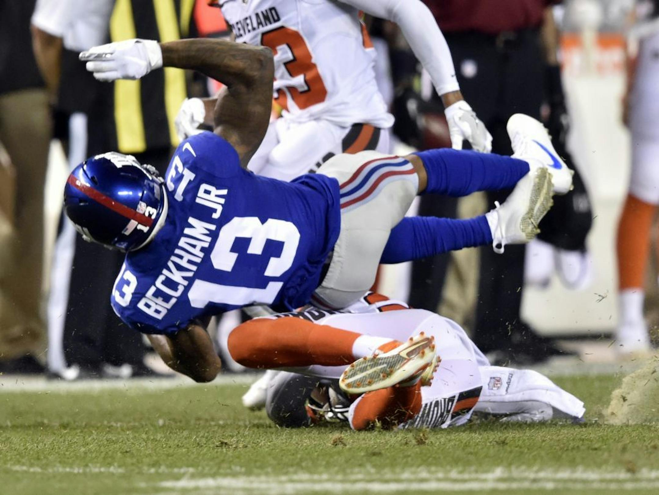 New York Giants wide receiver Odell Beckham (13) is tackled by Cleveland Browns strong safety Briean Boddy-Calhoun (20) in the first half of an NFL preseason football game, Monday, Aug. 21, 2017, in Cleveland.