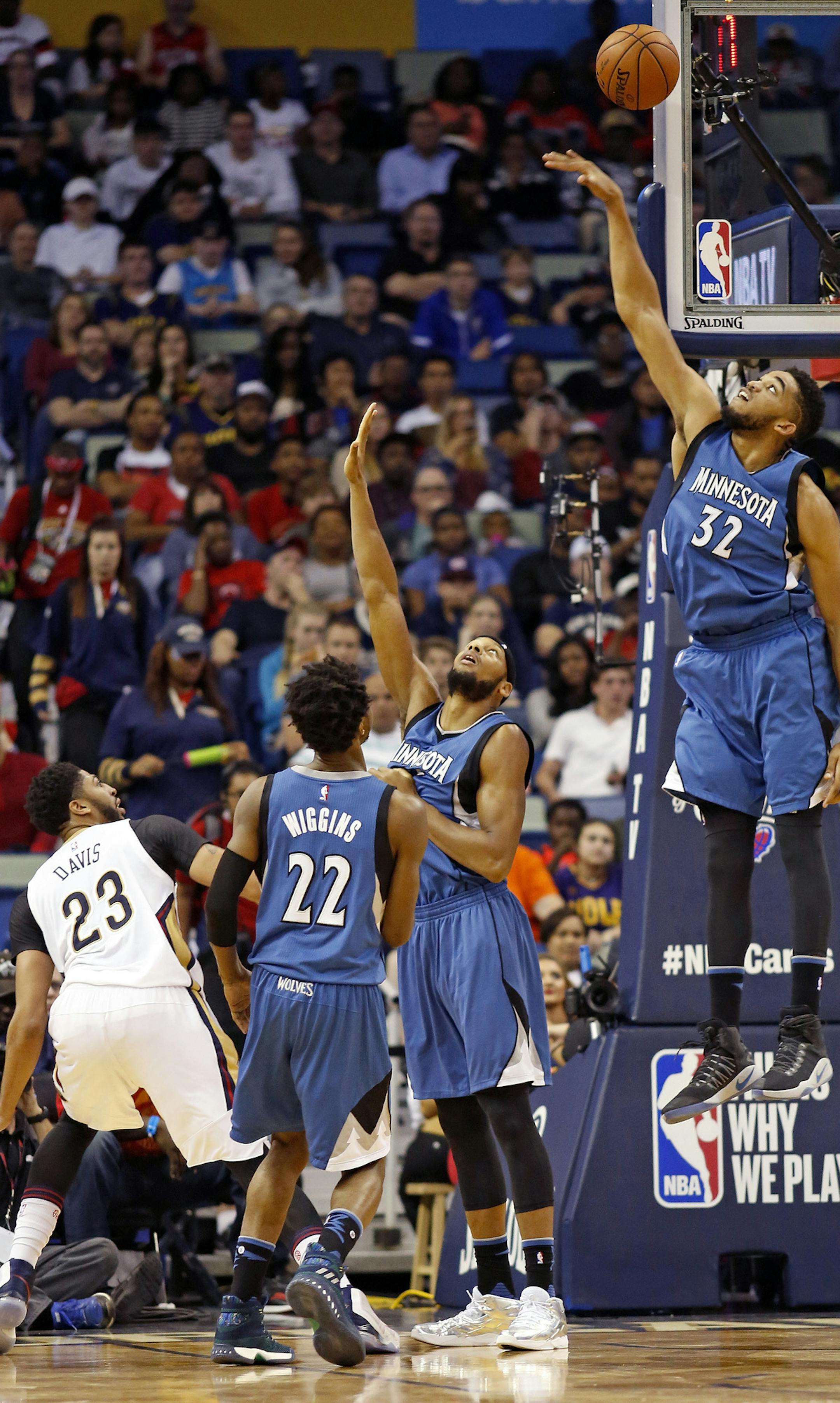 New Orleans Pelicans forward Anthony Davis (23) watches his shot over Minnesota Timberwolves forward Andrew Wiggins, forward Adreian Payne and center Karl-Anthony Towns, from left, during the first half of an NBA basketball game in New Orleans, Wednesday, Nov. 23, 2016. (AP Photo/Max Becherer)