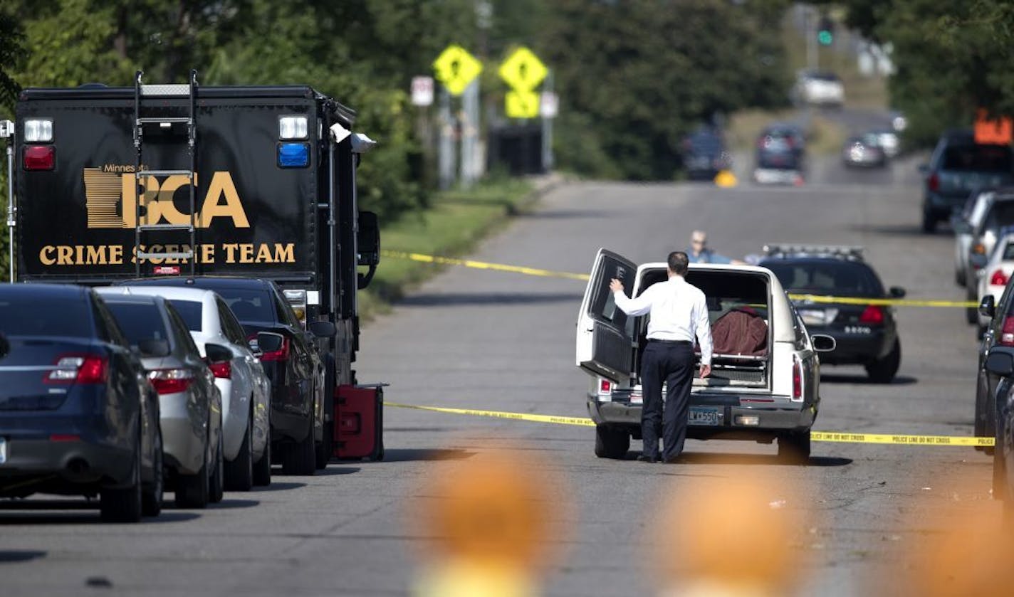 Ramsey county corner loaded the body of a person that was shot and killed by St. Paul Police in the 900 block of St. Anthony Avenue Sunday August 5, 2018 in St. Paul, MN.