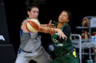 Seattle Storm forward Alysha Clark, right, and Minnesota Lynx guard Bridget Carleton battle for the ball during the first half of Game 2 of a WNBA bas