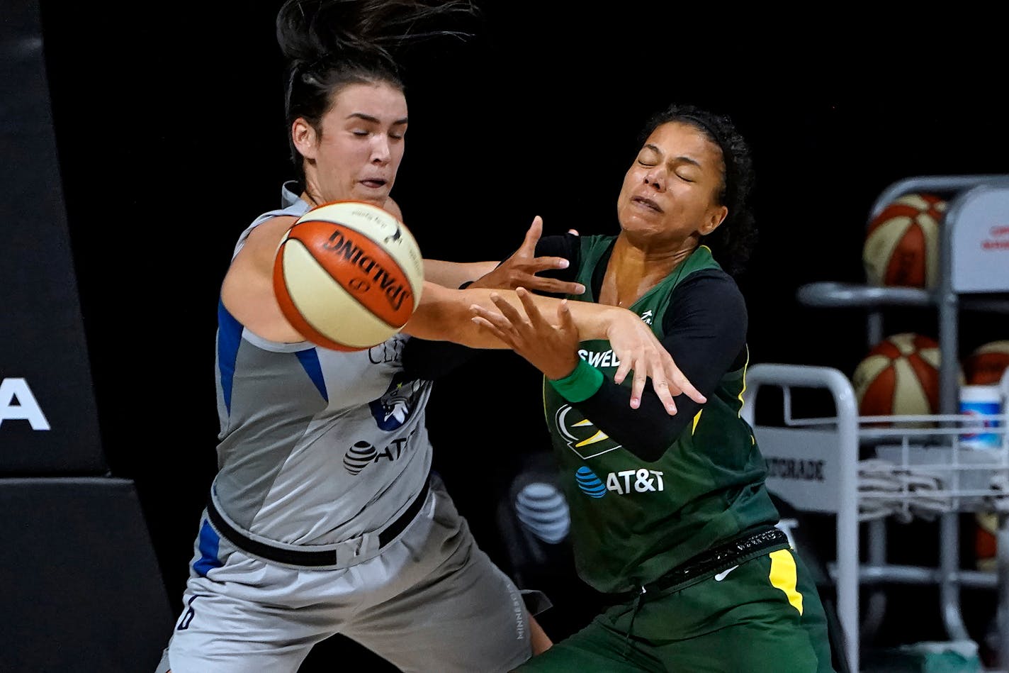 Seattle Storm forward Alysha Clark, right, and Minnesota Lynx guard Bridget Carleton battle for the ball during the first half of Game 2 of a WNBA basketball semifinal round playoff series Thursday, Sept. 24, 2020, in Bradenton, Fla. (AP Photo/Chris O'Meara)