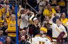 Logan Cooley of Minnesota celebrates in front of a friendly crowd after scoring an empty net goal in the third period.