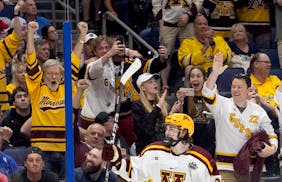 Logan Cooley of Minnesota celebrates in front of a friendly crowd after scoring an empty net goal in the third period.