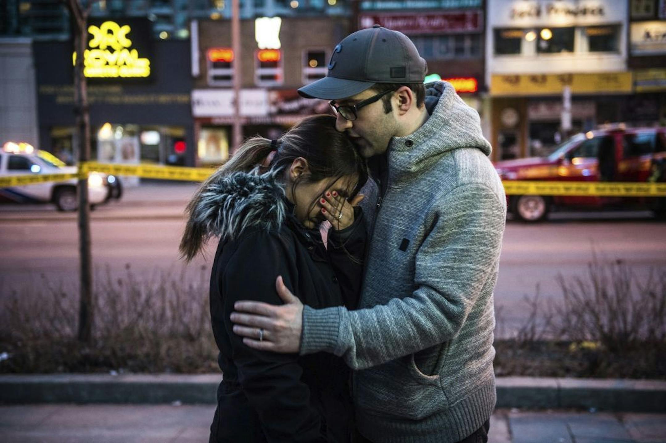 Farzad Salehi consoles his wife, Mehrsa Marjani, who was at a nearby cafe and witnessed the aftermath when a van plowed down a crowded sidewalk, killing multiple people and injuring others, Monday, April 23, 2018, in Toronto.