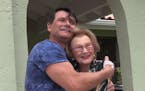 Fabio Franca greets Alice Modine, 94, at her Boca Raton house. Modine drove her car into a pond Friday and was rescued by an unknown man. But the two 