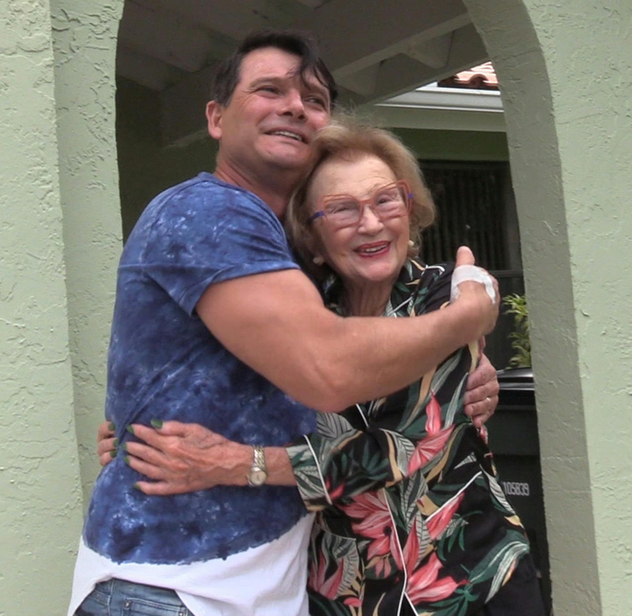 Fabio Franca greets Alice Modine, 94, at her Boca Raton house. Modine drove her car into a pond Friday and was rescued by an unknown man. But the two came into contact this weekend, talked on the phone and finally got to meet each other in person. (Mike Stocker/Sun Sentinel/TNS)