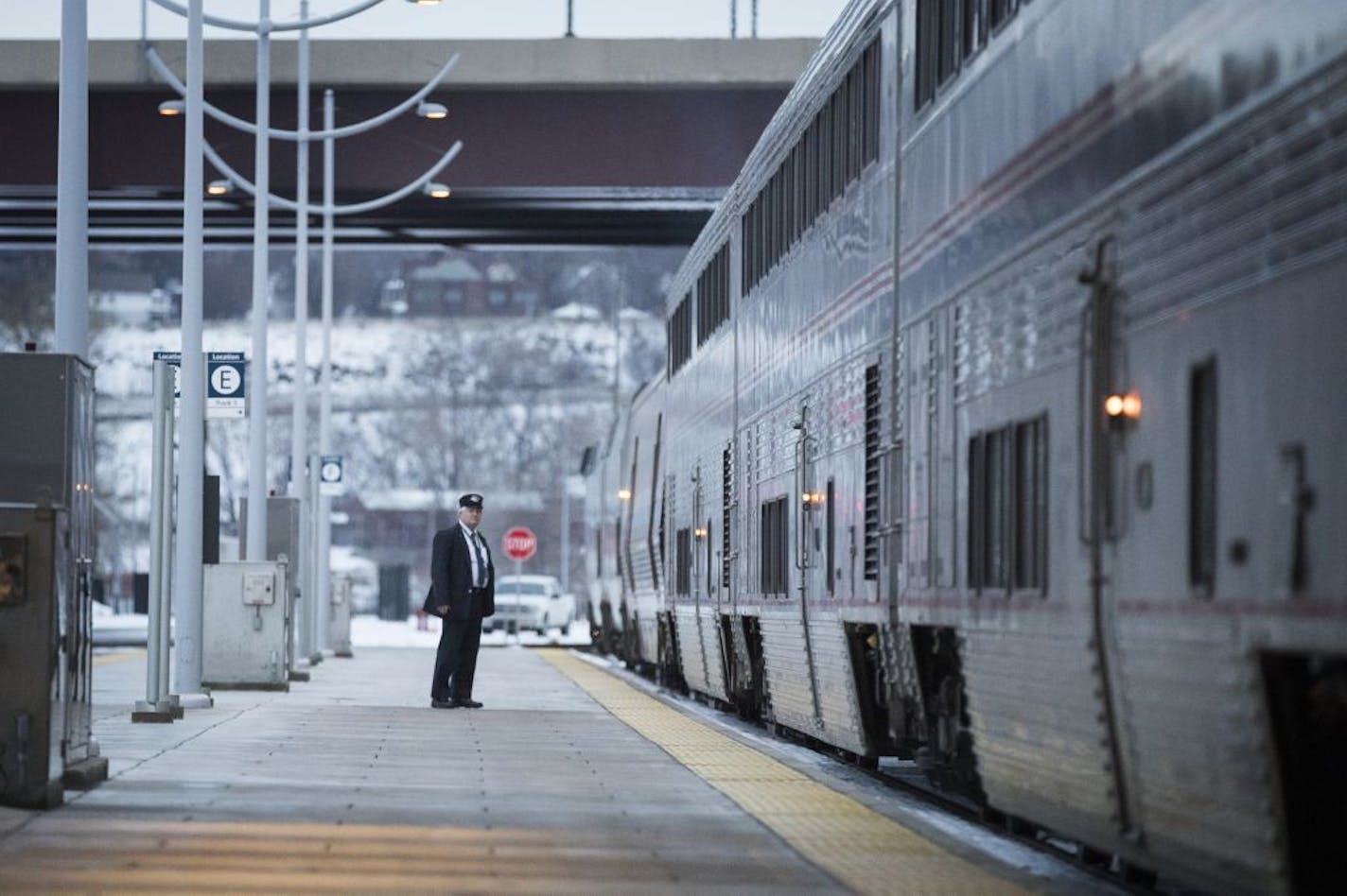 An Amtrak crew member checks to make sure all passengers have gotten on the train before it departs to Chicago.