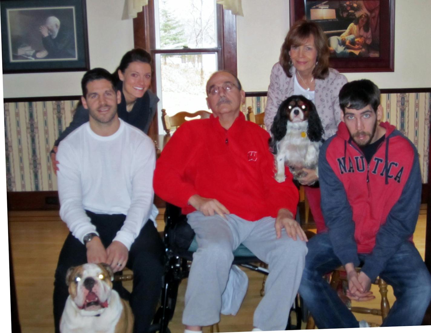 Jake Dowell's father, John, is in the center of this family photo. The rest of the family is Jake's wife, Carly (behind Jake on left); his mother, Vicki (back right) and brother Luke (front right). John and Luke Dowell have Huntington's disease, and Jake could either get it or carry the gene that passes it from generation to generation.