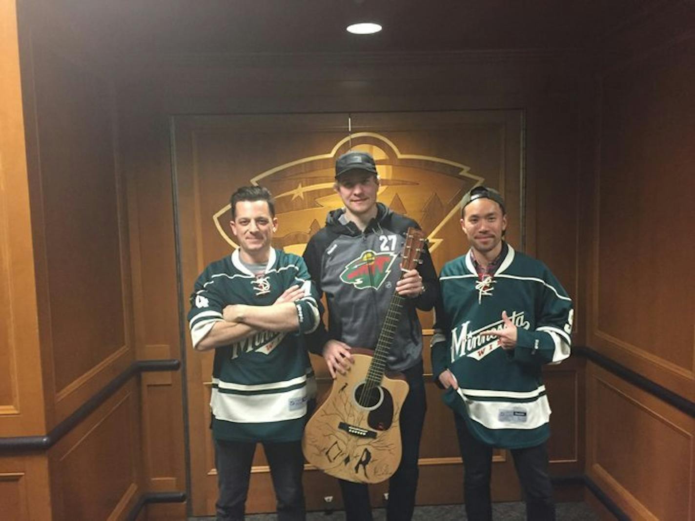 O.A.R. lead singer Marc Roberge and guitarist Richard On, after autographing and drawing a design on Zac Dalpe's guitar, pose with the Wild center after the three jammed at Xcel Energy Center on Thursday