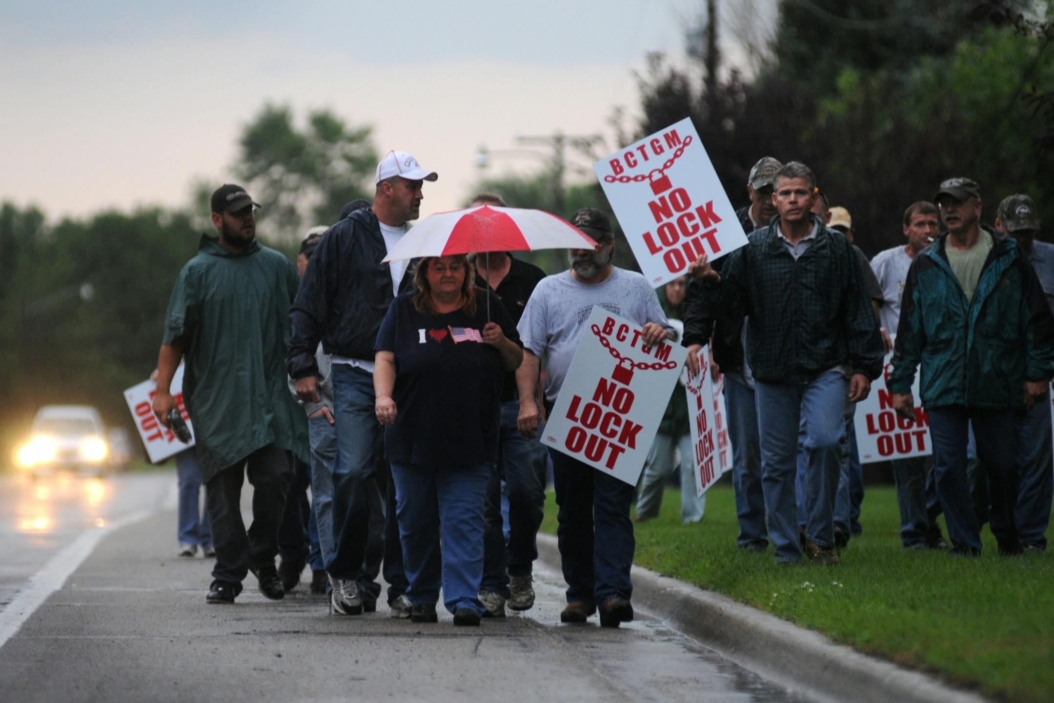 Employees walked down the road with picket signs during the first day of a lock-out Monday outside of the sugar beet plant in Moorhead.