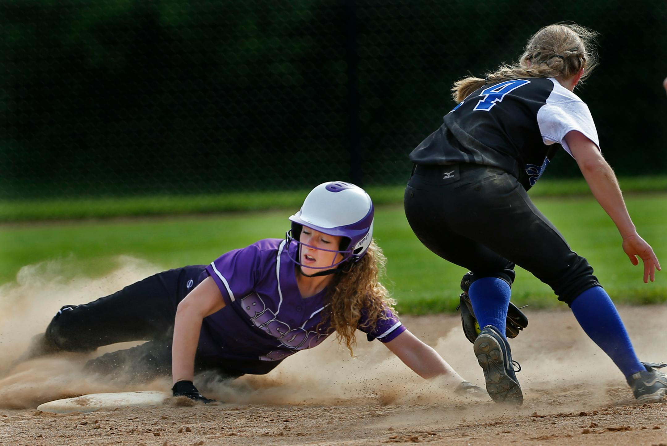 Kirsten Maygaard slides safely into second past the tag of Hopkins' Michelle Guenther. (Richard Tsong-Taatarii/Star Tribune)
