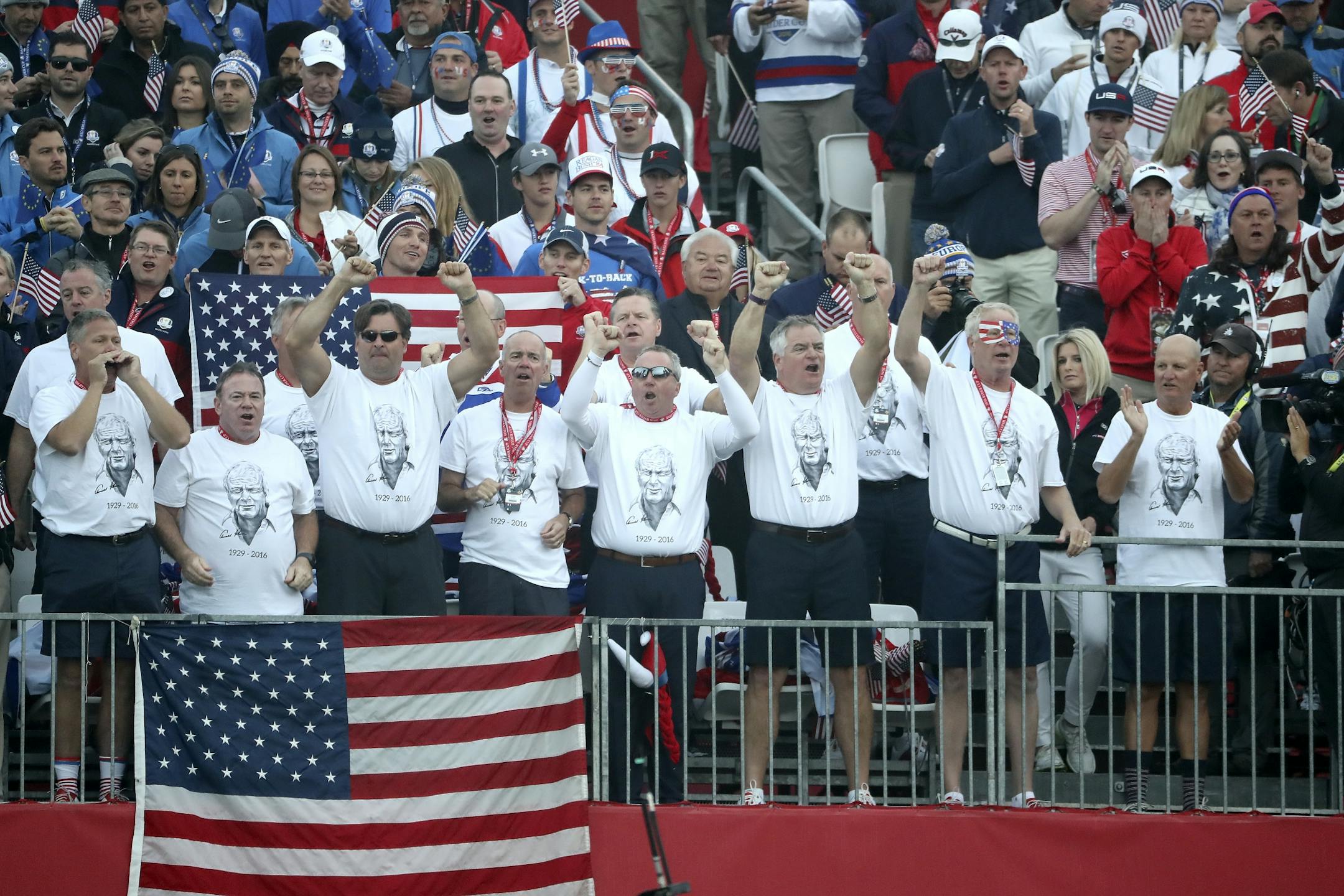Fans wearing Arnold Palmer t-shirts cheer on the USA players from the first tee Friday morning.