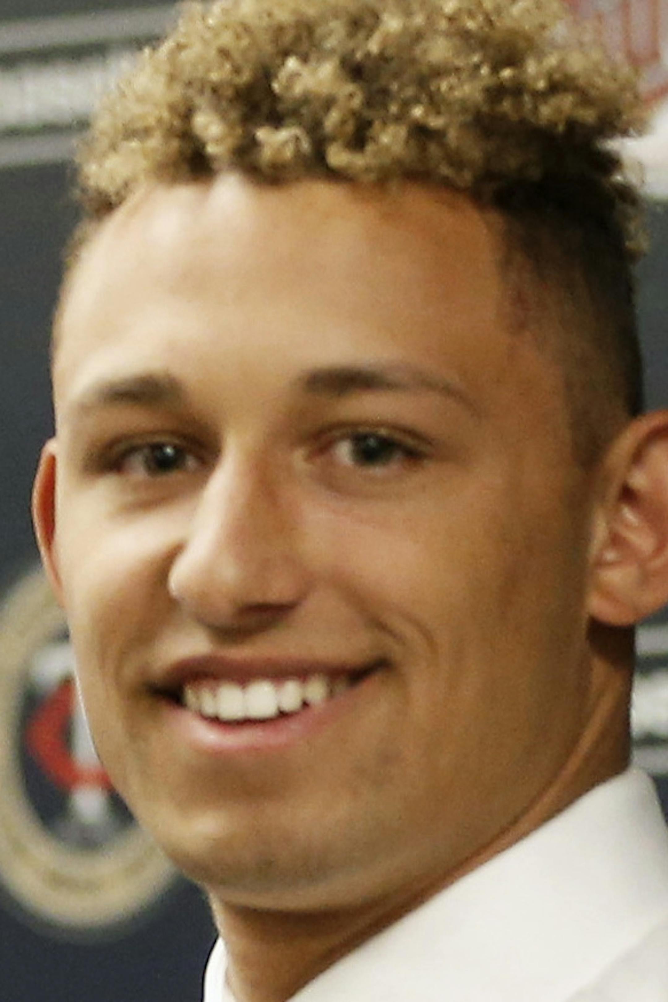Minnesota Twins chief baseball officer Derek Falvey, left, and first overall MLB draft pick Royce Lewis, hold up his new jersey as he was introduced to the media between a double-header with the Twins and Cleveland Indians, Saturday, June 17, 2017, in Minneapolis. (AP Photo/Jim Mone)