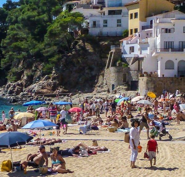 Cliffside inns, homes and restaurants climb the hill above the beach in Llfranc, Costa Brava, Catalonia, Spain. (Courtesy Steve Haggerty/Colorworld/MC