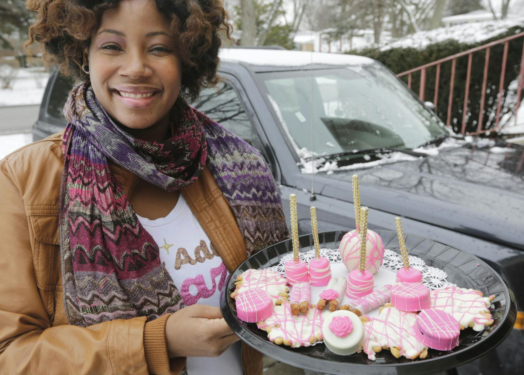 In this Tuesday, Jan. 27, 2015 photo, Kristen Harris, owner of Pizzazzed, a home-based baked goods business, displays some of her goodies, in Glenwood, Ill. The drop in gas prices allowed Harris to expand her delivery area; she had to cut it back when prices got too high. Sheís considering buying a second delivery truck. (AP Photo/M. Spencer Green) ORG XMIT: ILMG202