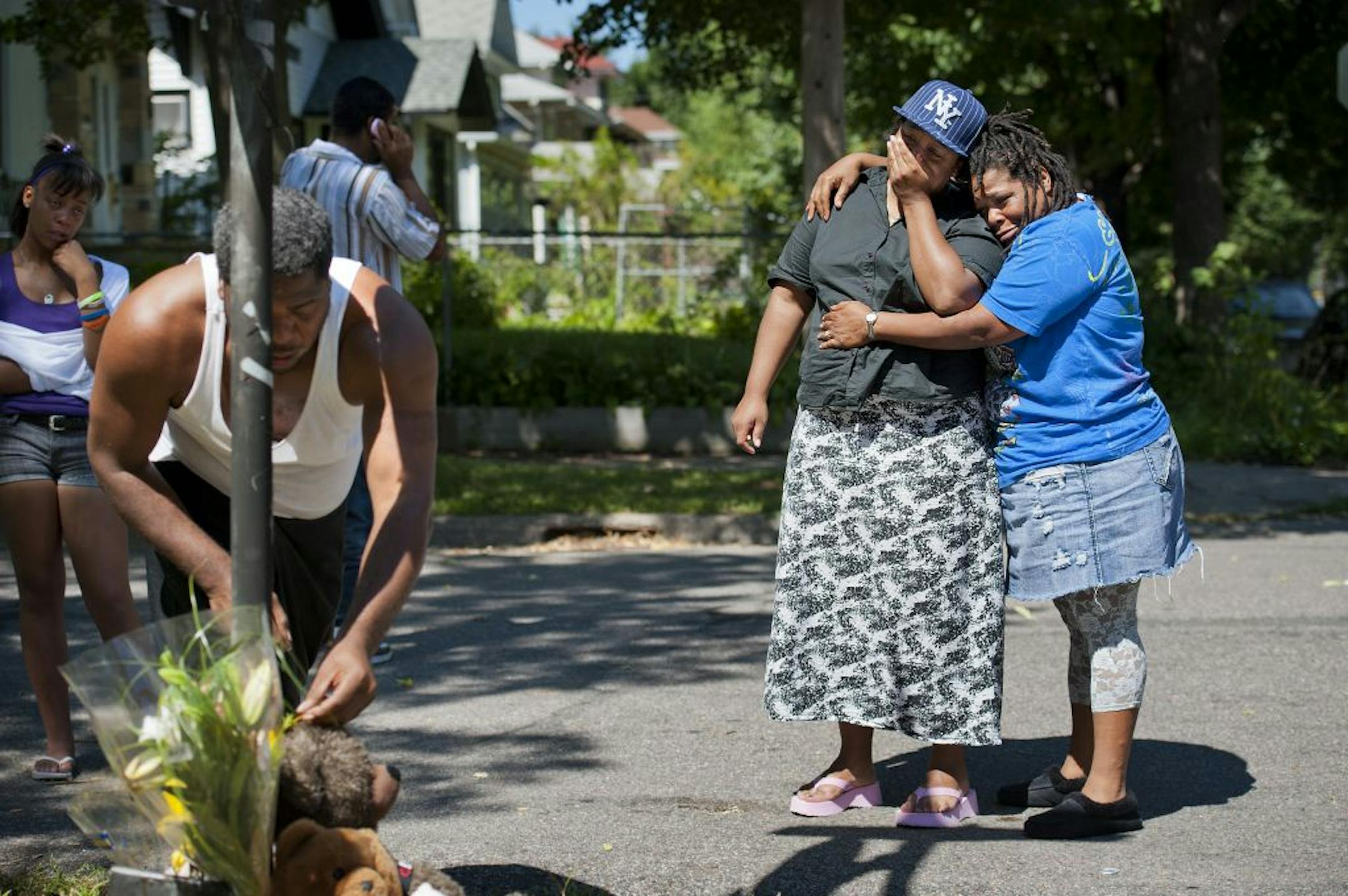 Cindy Braxton cried and was hugged by relative Pricilla Harris, right as they looked at the memorial for Cindy's murdered son 14-year-old Quantell Braxton Monday August 22, 2011. On the left is uncle Kevin Braxton and Quantell's girlfriend Samari Smith