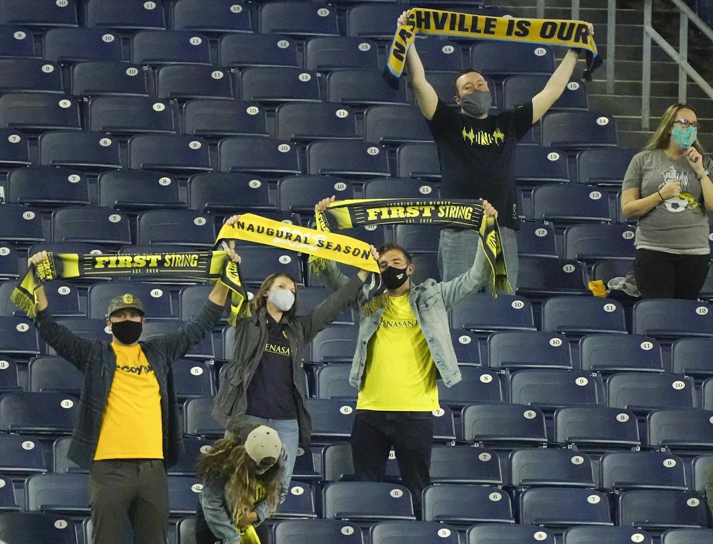 Nashville SC fans cheer as players are introduced before an MLS soccer match against Minnesota United on Tuesday, Oct. 6, 2020, in Nashville, Tenn. It is the first Nashville home game fans have been allowed in to see since the COVID-19 pandemic began. (AP Photo/Mark Humphrey)