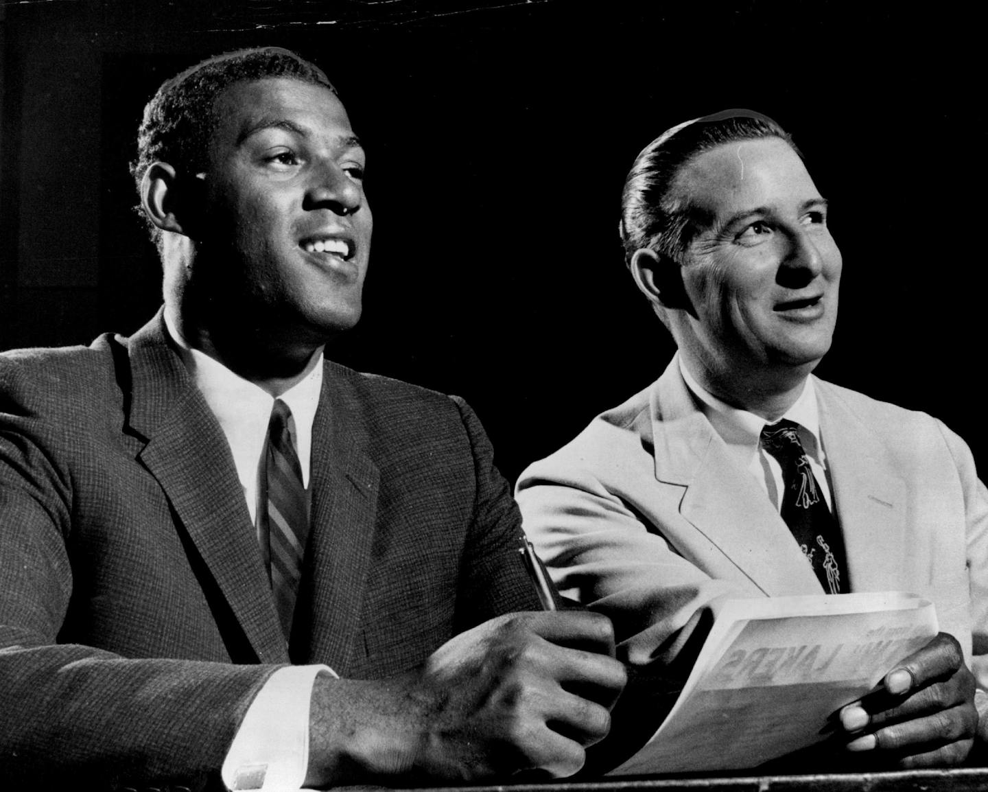 Elgin Baylor signed with the Lakers, and team president Bob Short, in 1958.