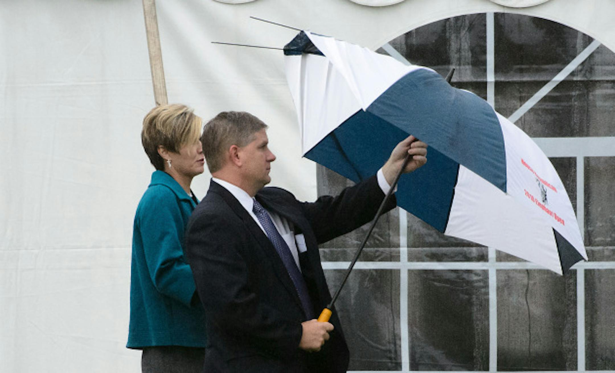 State Rep. Kurt Zellers had trouble with his umbrella as he left Sen. Grams service.  Sen. Rod Grams funeral service, Tuesday, October 15, 2013   A large tent was erected next to the Zion Lutheran Church in St. Francis to handle the large crowd.      ]   GLEN STUBBE * gstubbe@startribune.com