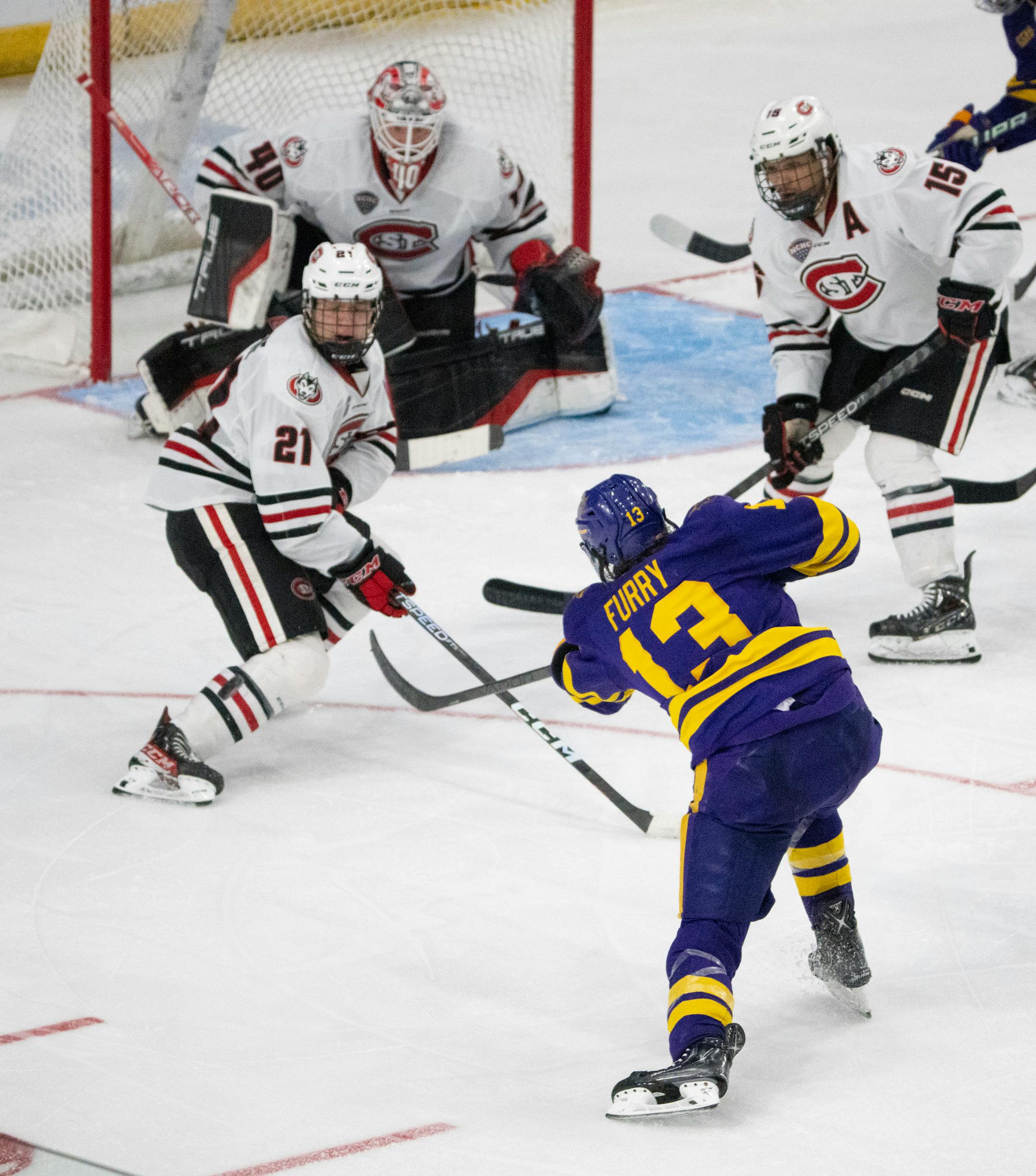 St. Cloud State Huskies defenseman Josh Luedtke (21) blocked a shot by Minnesota State Mavericks forward Brendan Furry (13) in the second period.