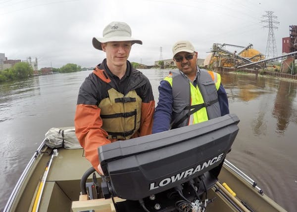 Researchers Brian Jastram and Udai Singh map the underwater topography of the Mississippi River's upper reaches in Minneapolis near the city's former 