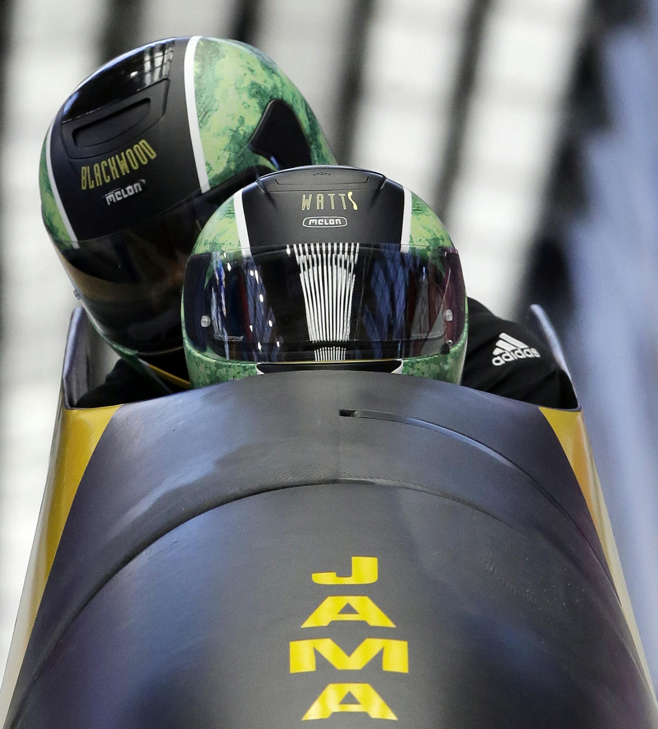 The two-man team from Jamaica JAM-1, piloted by Winston Watts, brake in the finish area during the men's two-man bobsled training at the 2014 Winter Olympics, Thursday, Feb. 13, 2014, in Krasnaya Polyana, Russia. (AP Photo/Dita Alangkara)