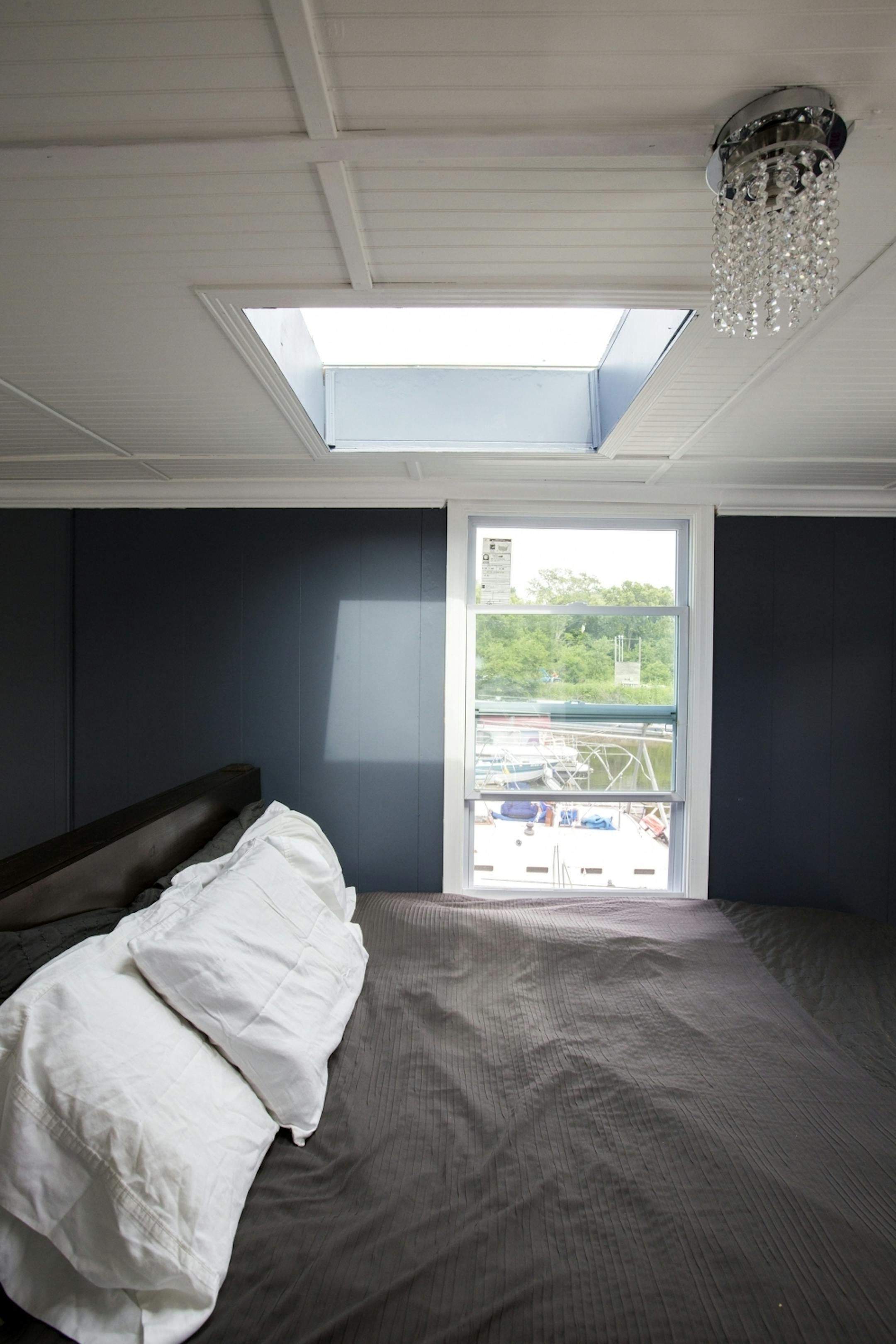 The bedroom has a skylight above the bed -- and a small crystal chandelier.