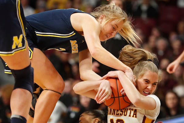 Gophers guard Mara Braun, right, battled for a loose ball with Michigan’s Maddie Nolan on Jan. 29 at Williams Arena. Minnesota will play visiting Wi