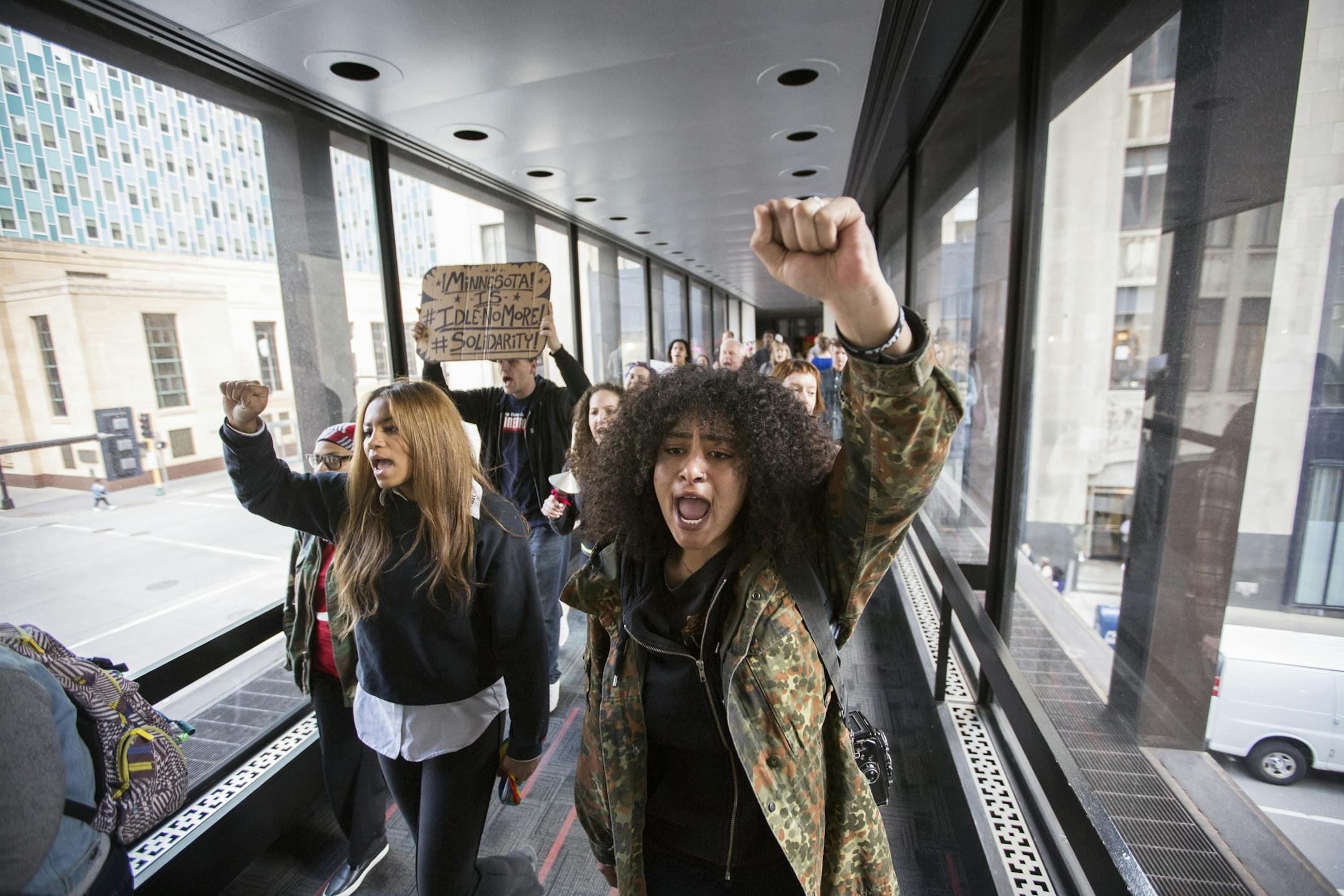 Marcellina Reis chants and marches with others through the skyways during a "Freeman Friday" march.
