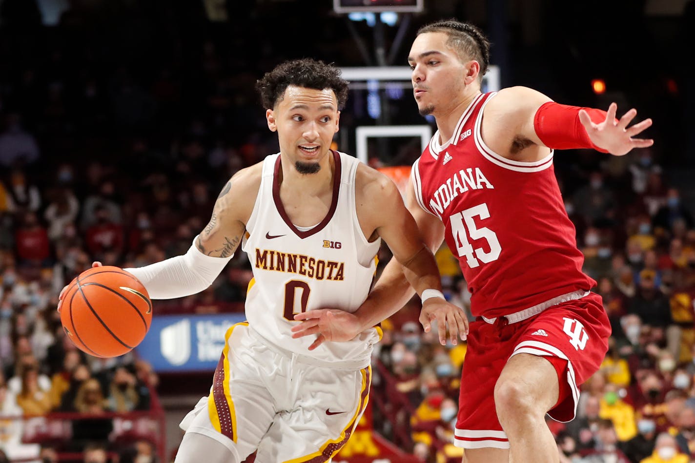 Minnesota guard Payton Willis (0) works around Indiana guard Parker Stewart (45) in the first half of an NCAA college basketball game Sunday, Feb. 27, 2022, in Minneapolis. (AP Photo/Bruce Kluckhohn)