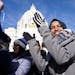 Rep. Ilhan Omar clapped from the steps of the State Capitol as she arrived to speak during the Women's March Saturday.