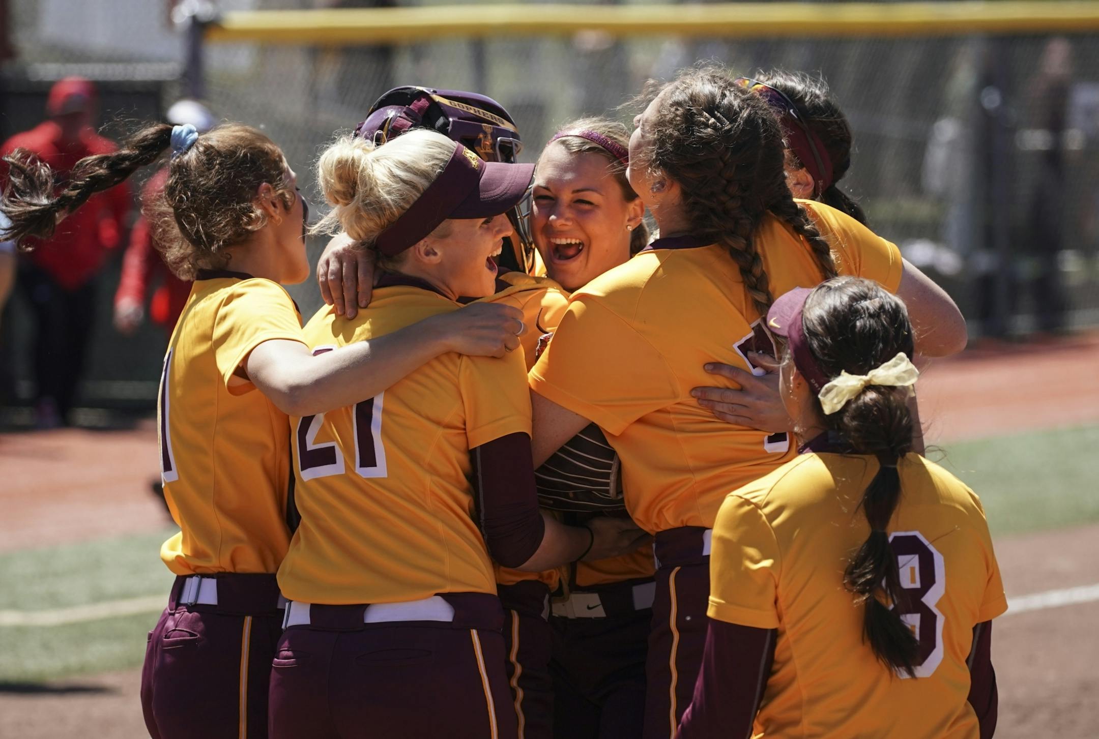 Gophers softball teammates hugged pitcher Amber Fiser (center) after she struck out a batter to end Monday's 8-1 victory over Georgia.
