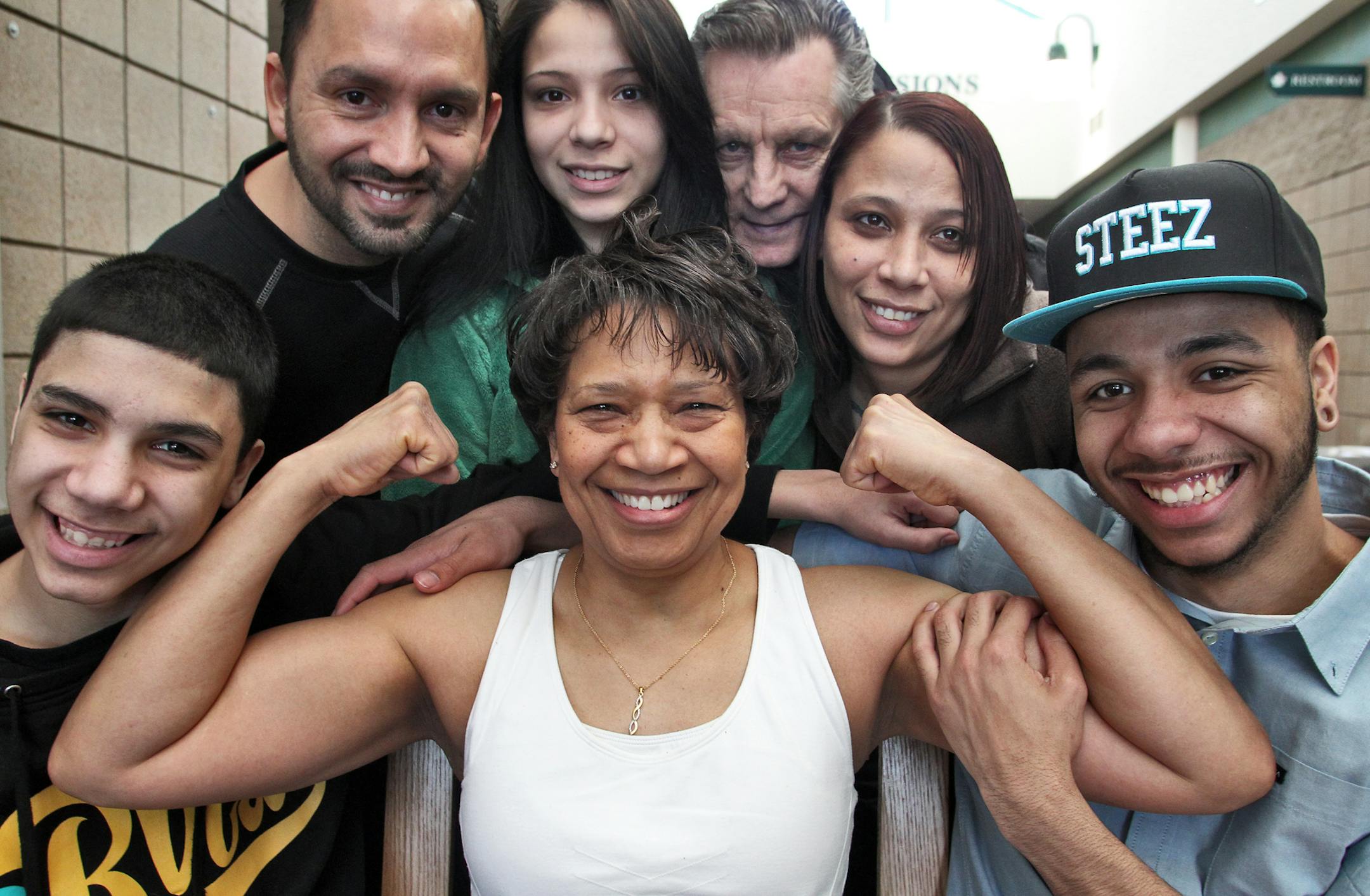 Bonnie Oliver, Maple Grove, is a grandmother who stays in shape by lifting weights. She enlists the support of family and friends to provide her moral and physical encouragement. Here, Bonnie Oliver, center, pumped her "guns" as family members and friends gathered around. Front row, l-r - Peter Villagomez Jr., Bonnie Oliver, Dre Oliver. Back row, l-r - Peter Villagomez, Sr., Areanna Villagomez, Paul Herskind, and Felicia Vill.
(MARLIN LEVISON/STARTRIBUNE(mlevison@startribune.com (cq -program) NO