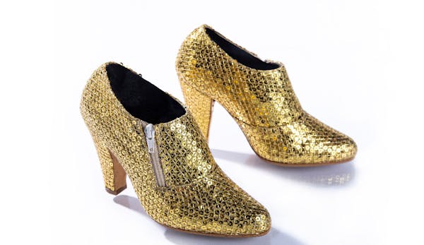 Prince wore these gold metallic shoes during his 2010-2011 Welcome 2 America Tour. All shows were performed on Prince's iconic Love Symbol stage and f