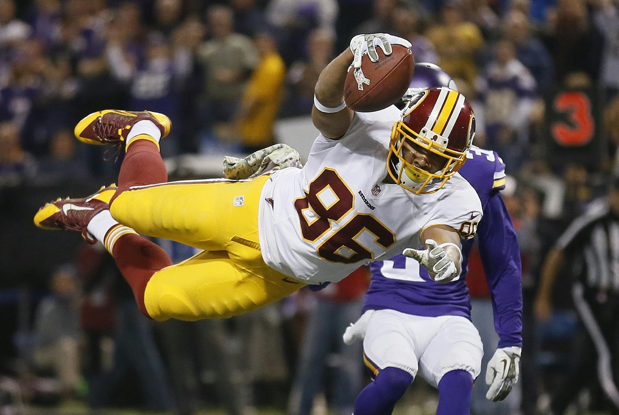 Washington's Jorday Reed dives into the endzone for a 2nd quarter TD. Viking's Marcus Sherels behind him.