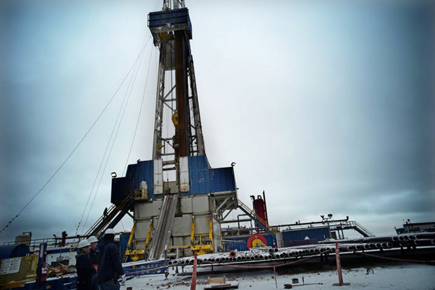 A rig was drilling three new wells in North Dakota in this file photo. Oil and gas production broke another record in July in the state. (Richard Tsong-Taatarii/Minneapolis Star Tribune/TNS) ORG XMIT: 1430823