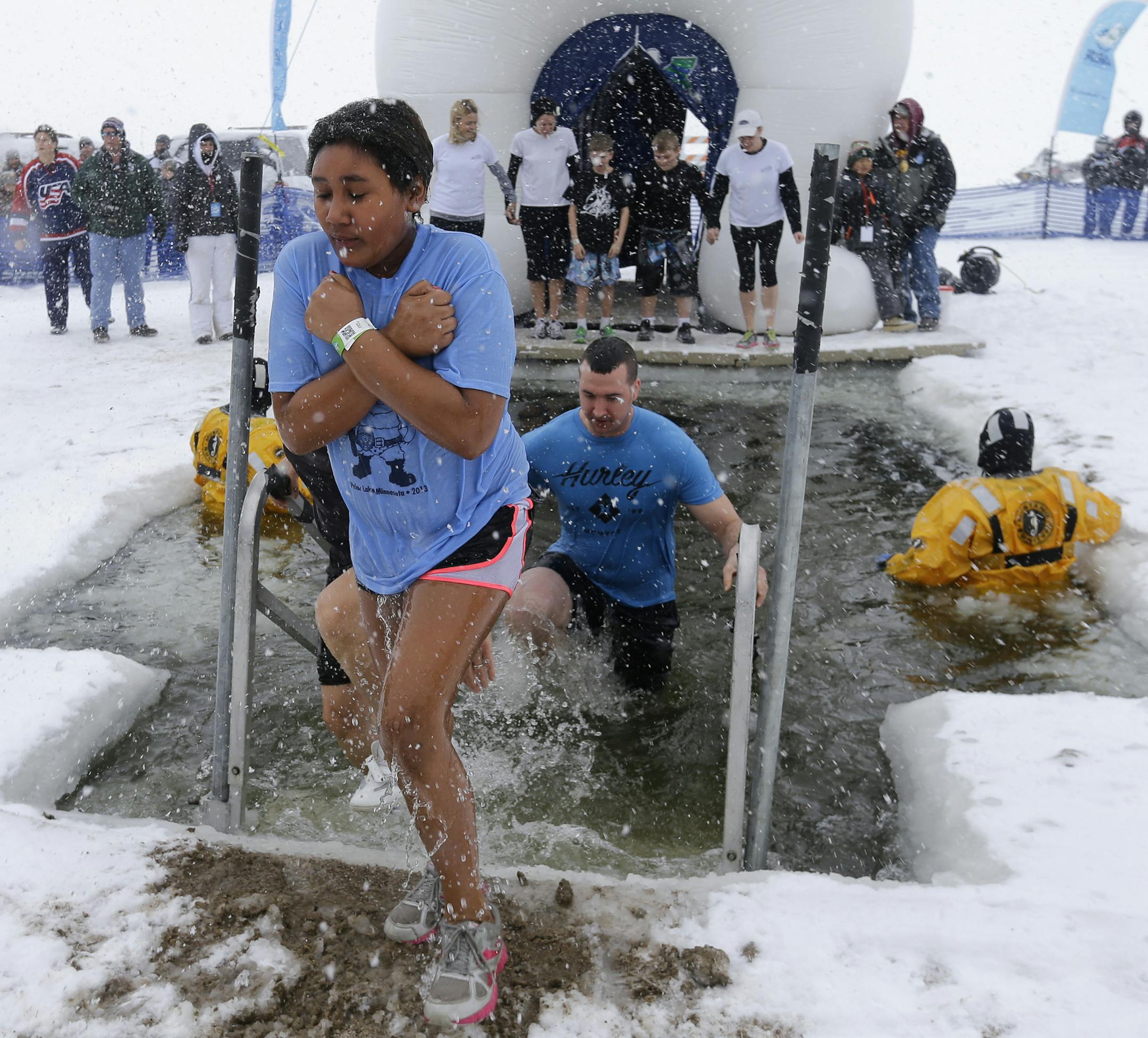 A plunger emerges from the icy waters at Sand Point Beach during a Polar Plunge for Special Olympics in Prior Lake, Saturday, Feb. 15, 2014. (Photo/Ann Heisenfelt) ORG XMIT: plunge0216142