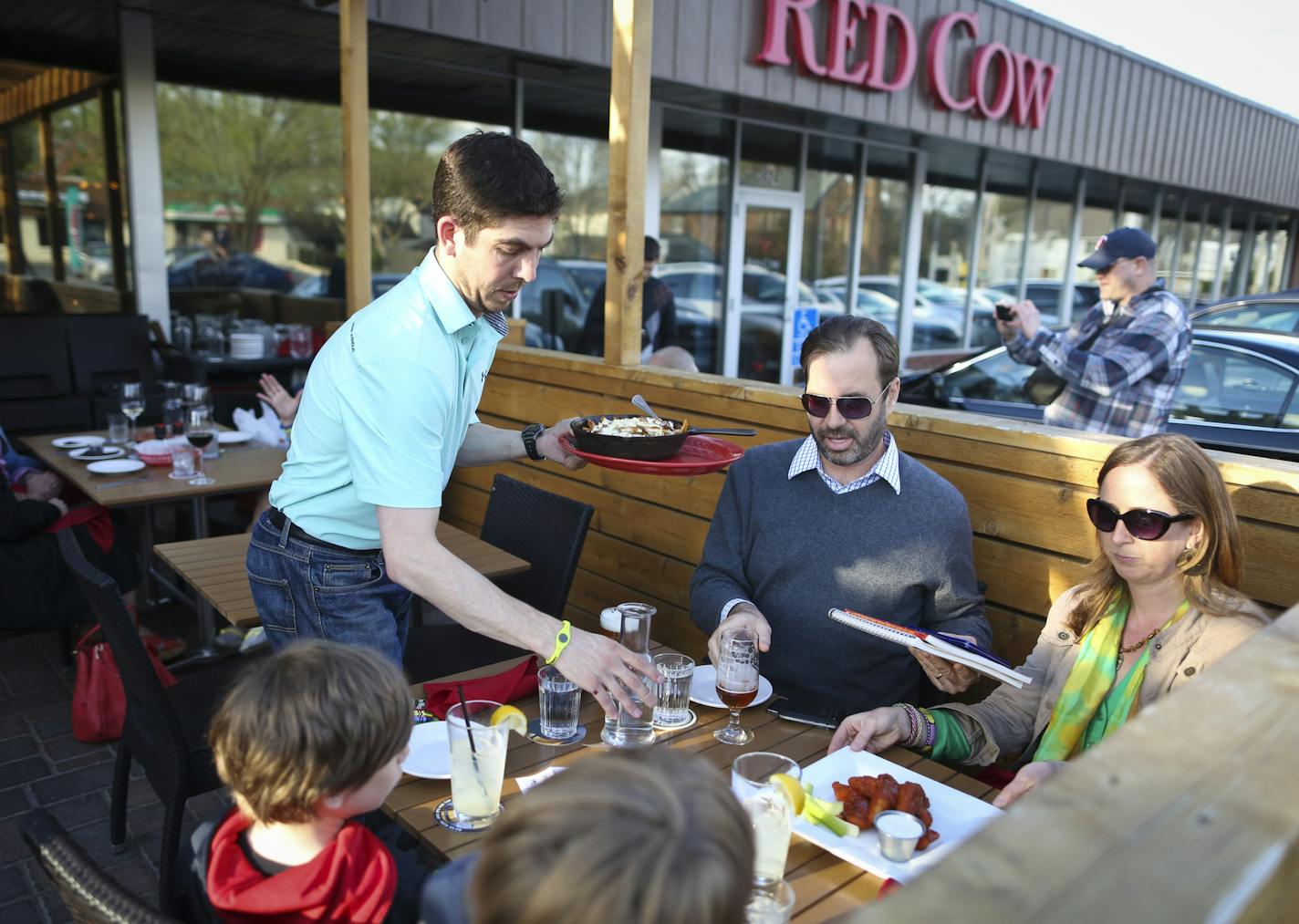 Jeff and Liz Genrich and their boys gather at the Red Cow, a former Blockbuster, where parking has been restricted.