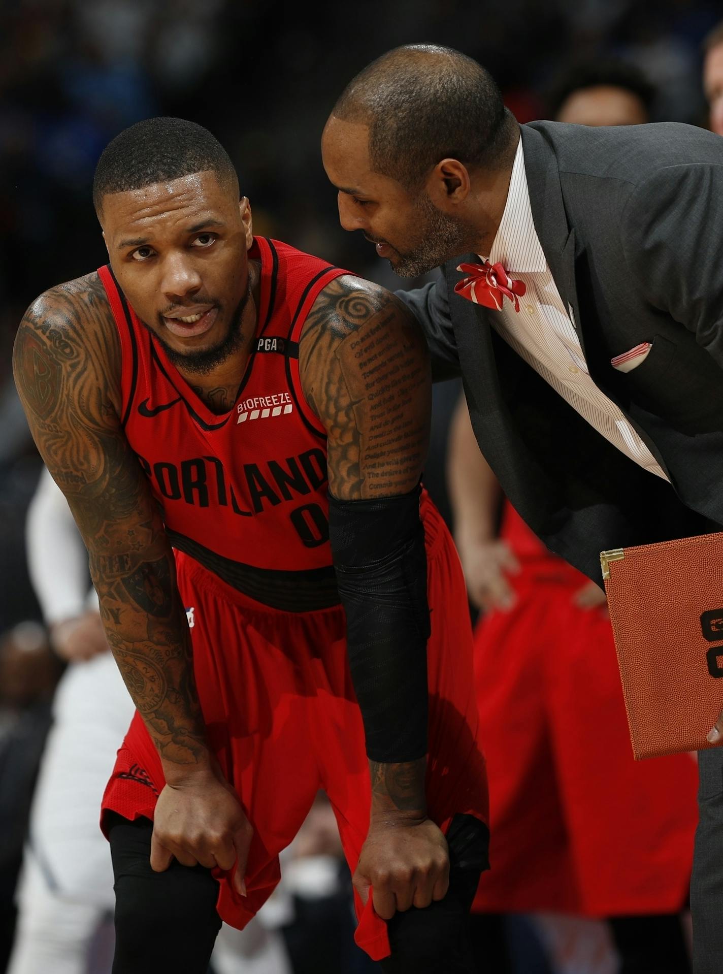 Portland Trail Blazers guard Damian Lillard (0) and assistant coach David Vanterpool in the second half of Game 2 of an NBA basketball second-round playoff series Wednesday, May 1, 2019, in Denver. Portland won 97-90. (AP Photo/David Zalubowski)