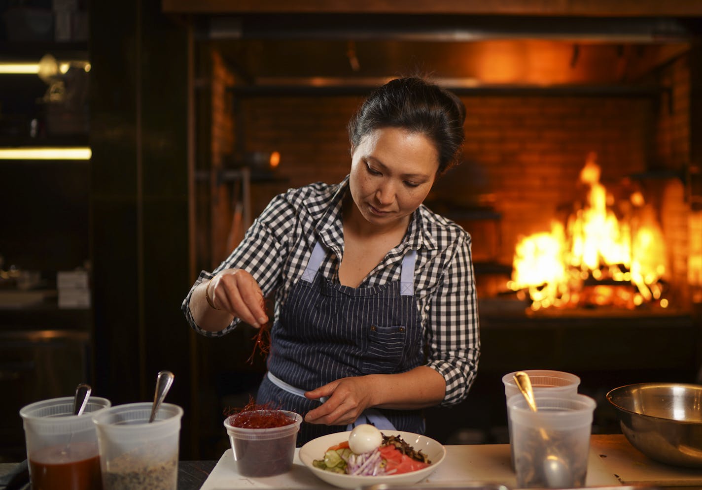 Ann Kim preparing a Bibim Grain salad at Young Joni. ] JEFF WHEELER &#x2022; Jeff.Wheeler@startribune.com Ann Kim prepared a Bibim Grain salad, offered at her Young Joni Tuesday afternoon, February 4, 2020 in Northeast Minneapolis.