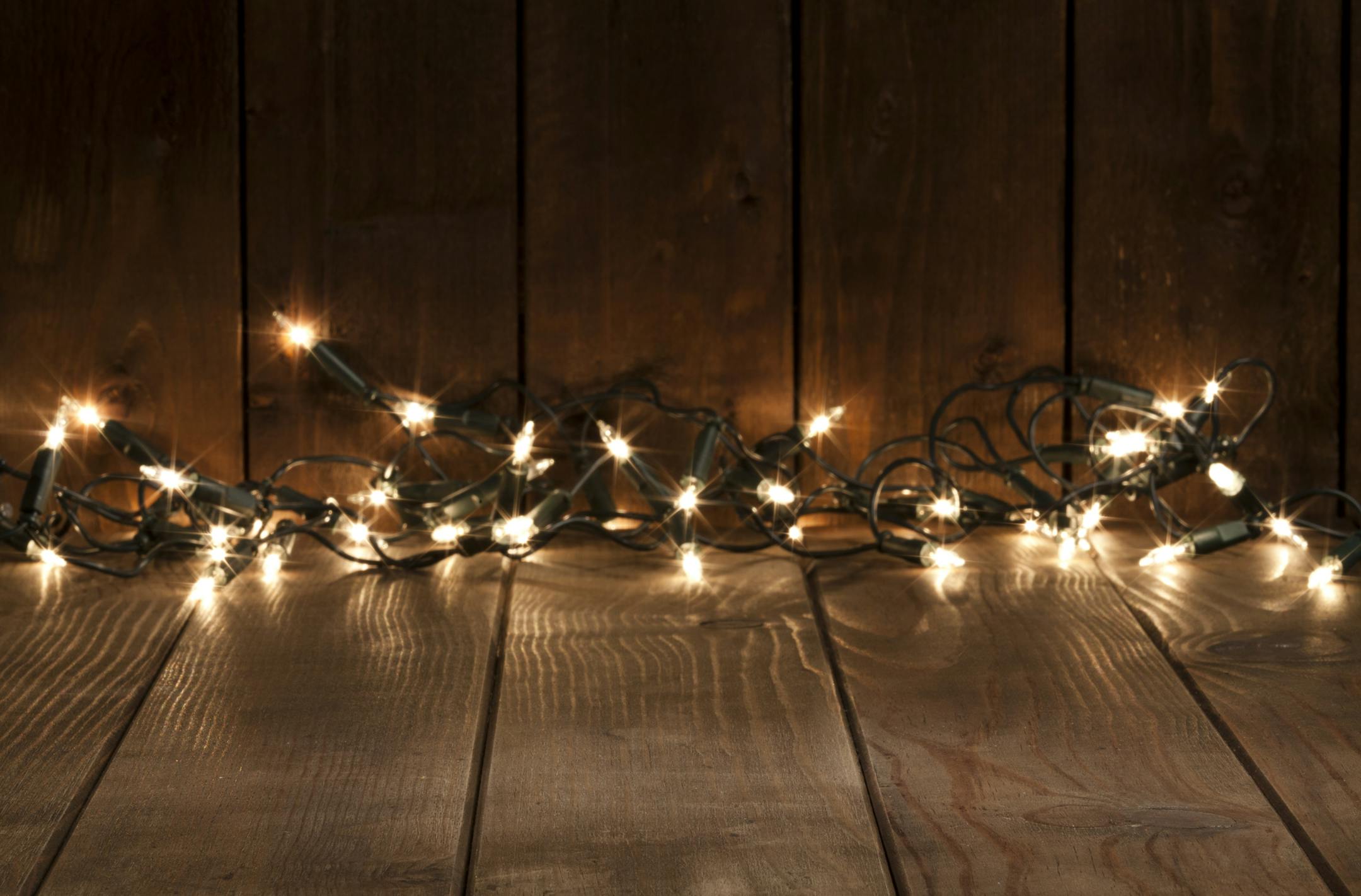 Empty rustic wooden table with defocused Christmas lights at background. Ideal for product display. Predominant colors are brown and yellow. DSRL studio photo taken with Canon EOS 5D Mk II and Canon EF 70-200mm f/2.8L IS II USM Telephoto Zoom Lens