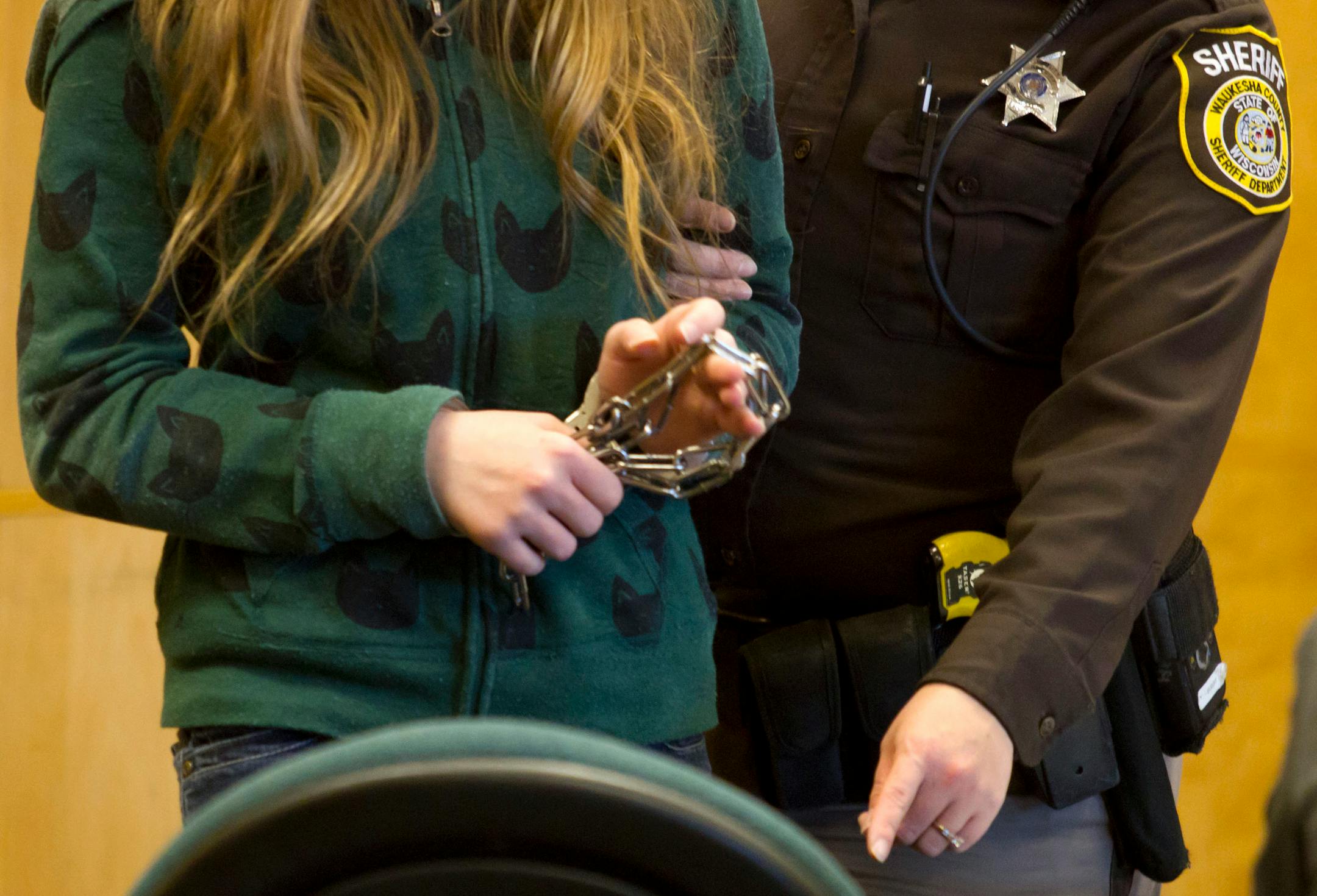 One of two 13-year-old girls accused of stabbing a classmate to please the fictional horror character Slender Man was led into a courtroom for a hearing in November in Waukesha, Wis.
