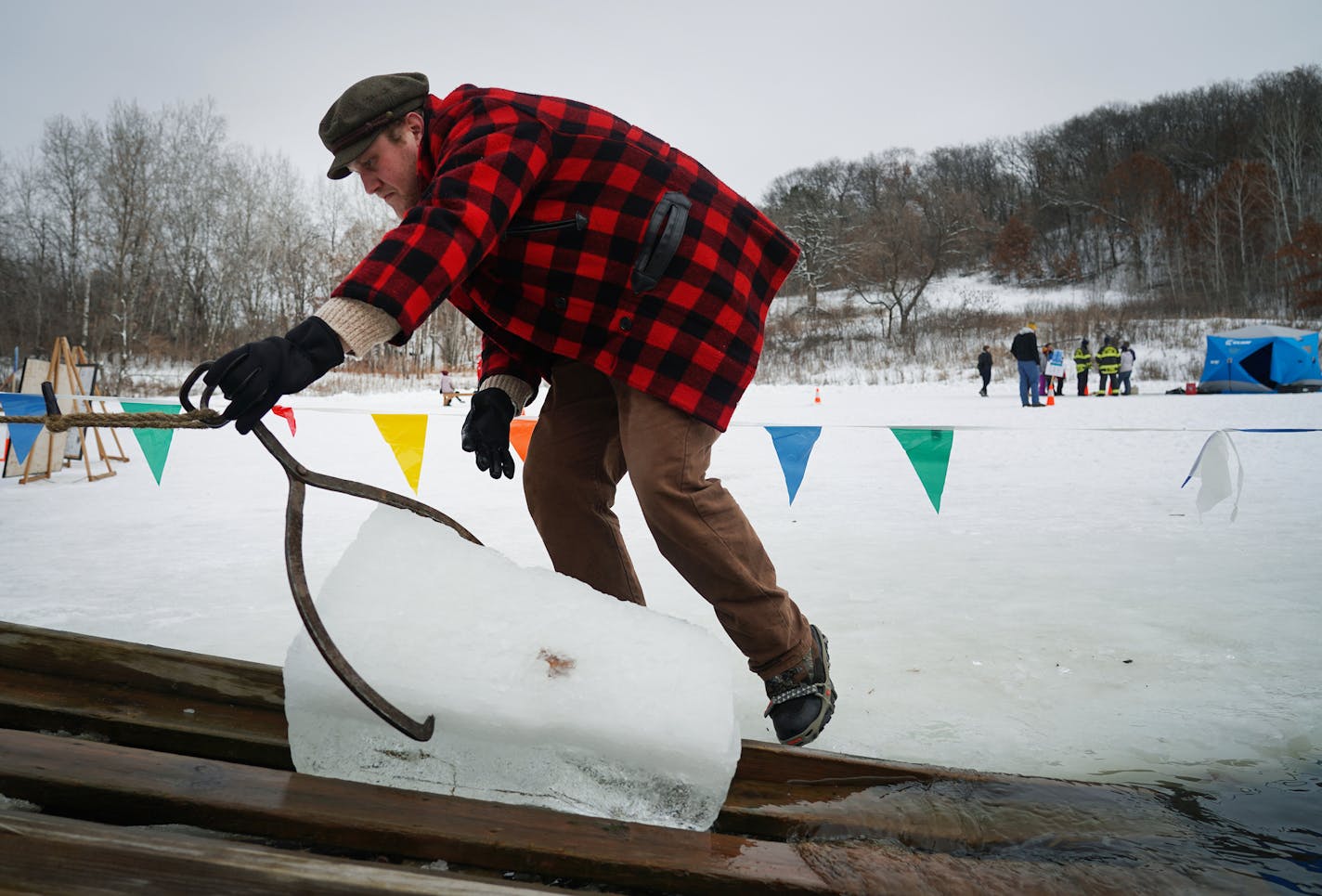 Three Rivers Park District employee Zack Mohlis pulled a block of ice from the water at Richardson Nature Center.