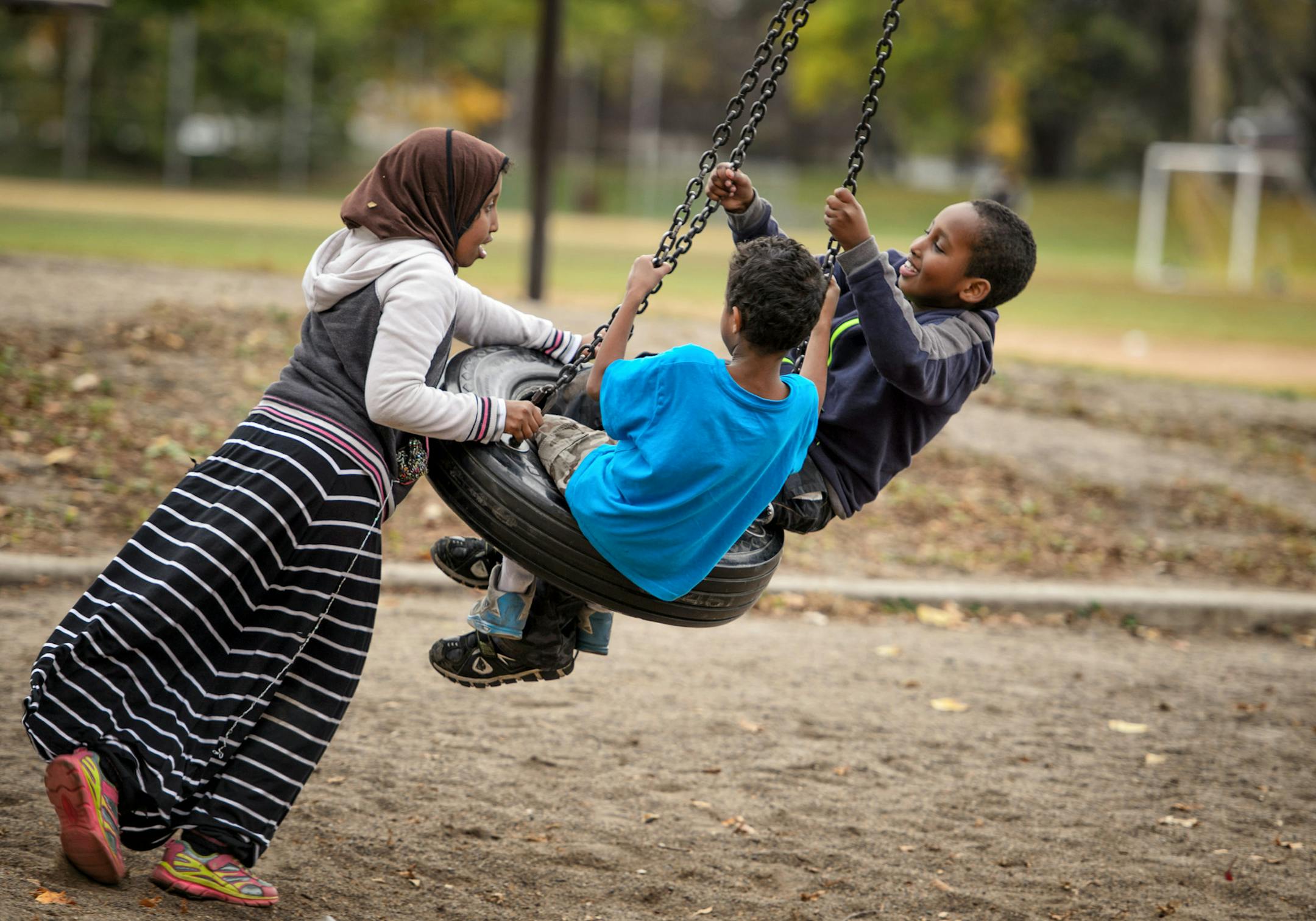 Children played on a tire swing in Matthews Park, Minneapolis. ] GLEN STUBBE * gstubbe@startribune.com Monday October 26, 2015 Luxton and Matthews parks and the Washburn Avenue totlot were supposed to get playground renovations next year. Phelps was to get a wading pool overhaul. Lyndale Farmstead and Painter parks were slated for building improvements. But all are being shoved off at least a year, along with 10 other future projects under a revamped capital proposal by Mpls. Park Supt. Jayne Mi