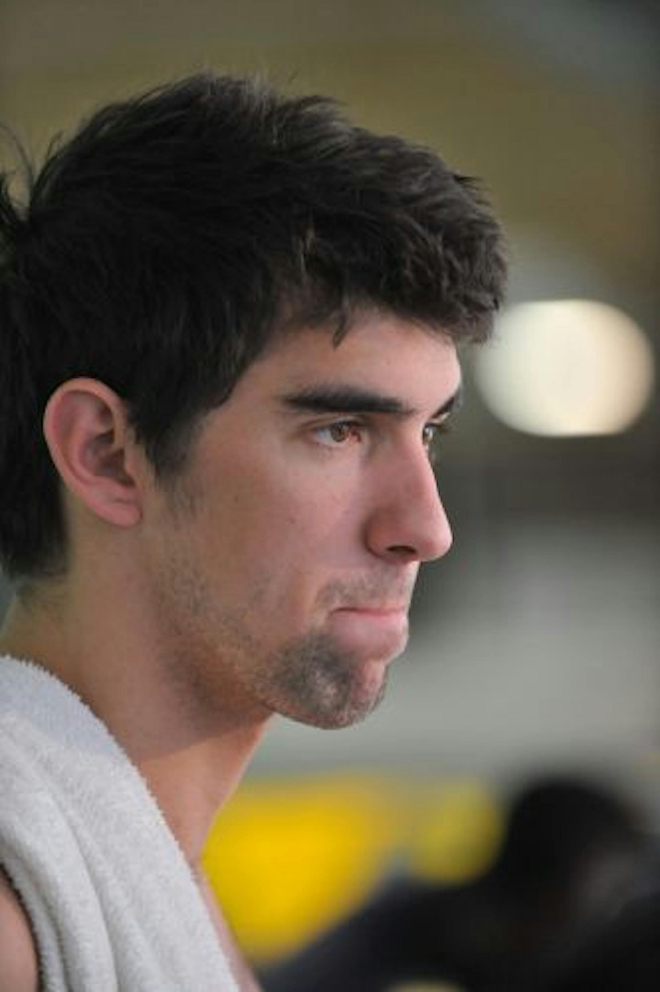 Olympic gold medalist Michael Phelps paused as he answered questions from reporters before training at the Meadowbrook Aquatic Center on Friday.