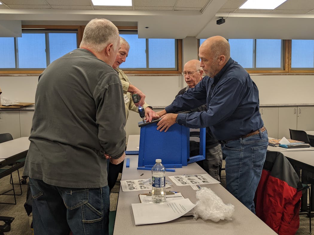 Members of the Hopkins Men's Shed work together on projects as part of their community service mission. They assembled Little Free Libraries at a recent meeting. 