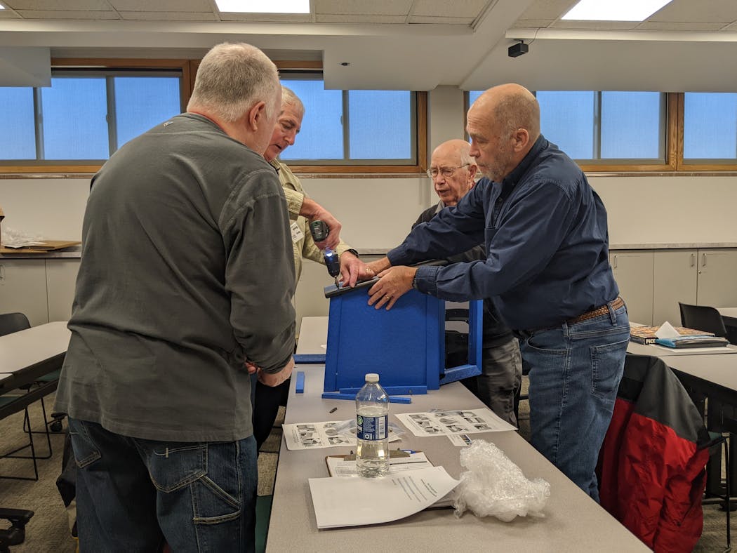 Members of the Hopkins Men's Shed work together on projects as part of their community service mission. They assembled Little Free Libraries at a recent meeting. 